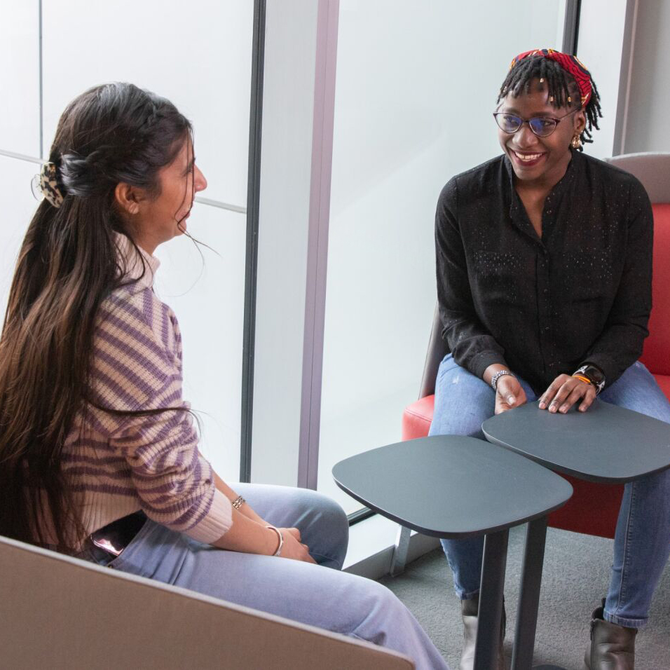 A student talking to a teacher in an informal setting