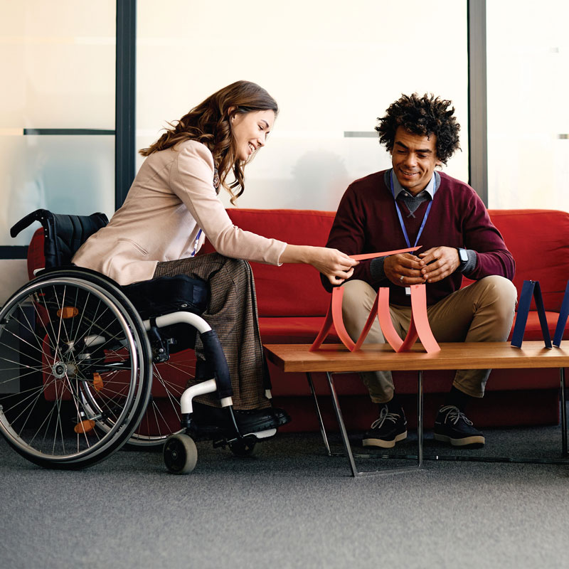 Two people doing a workshop activity. One person is in a wheelchair