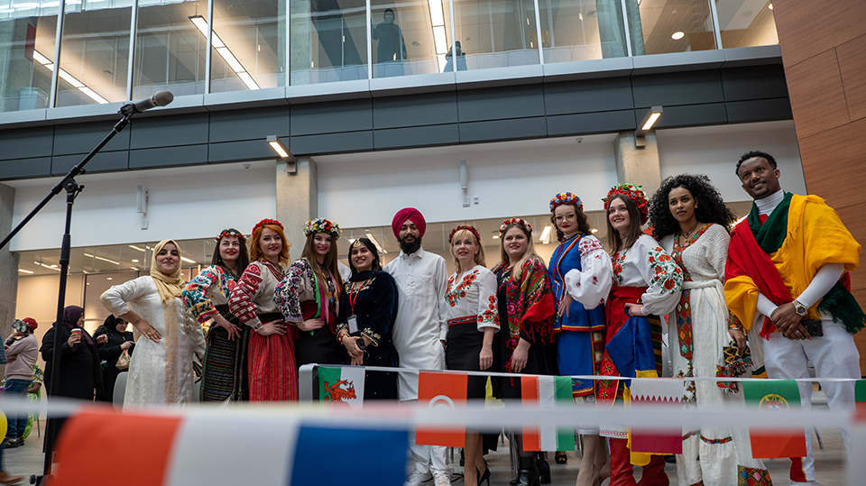 Group of people dressed in a variety of different traditional clothing