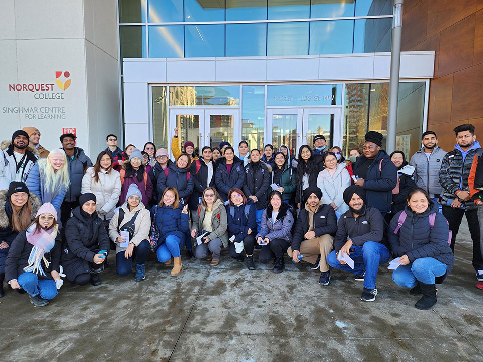 Group photo of students outside of Imagine Hall