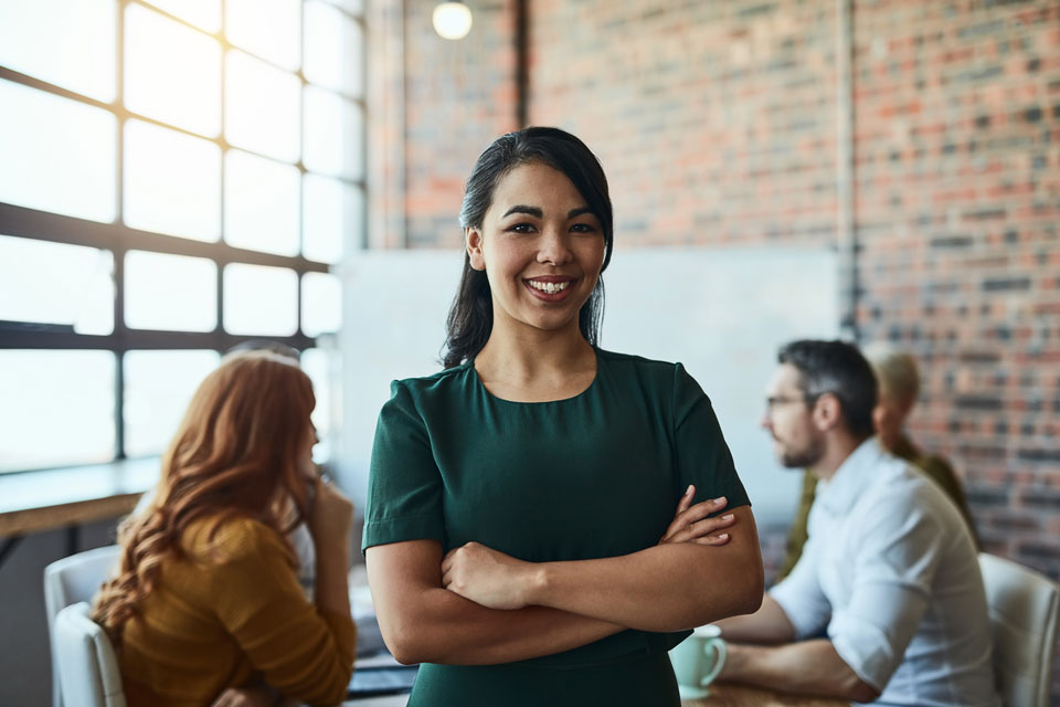 Smile, portrait and business woman with arms crossed in company startup meeting. Face, confidence and happy female leader, professional and person with pride for career, job and success mindset.