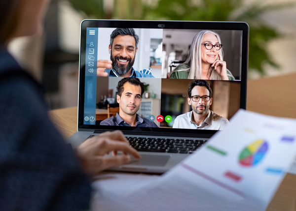 Someone attending an online meeting with several people on the screen