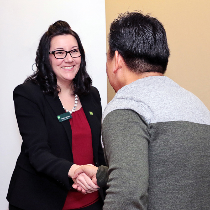 A donor shaking the hand of an award recipient